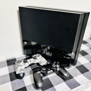 Sony PlayStation Console with Black and Camouflage Controllers